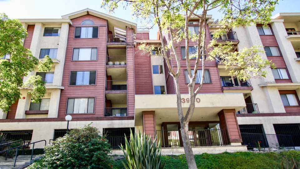 Five story red and white building with parking at Sunrise Point in College Area CA