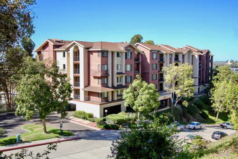 At Sunrise Point is located an amazing building. Housing habitants which are surrounded by green spaces full of trees. There is even playground space for your kids. The road passes nearby the building. The colour of the building blends good with the envir