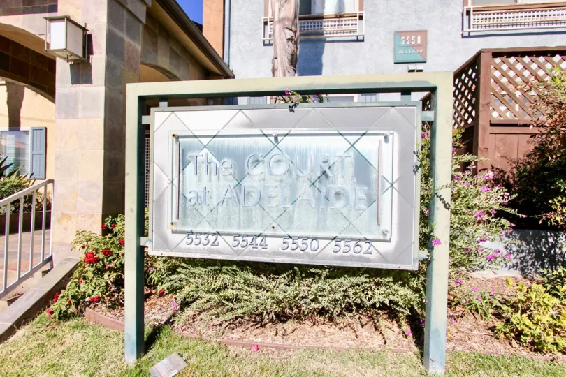 A sign for The Court at Adelaide apartments in College Area, California.