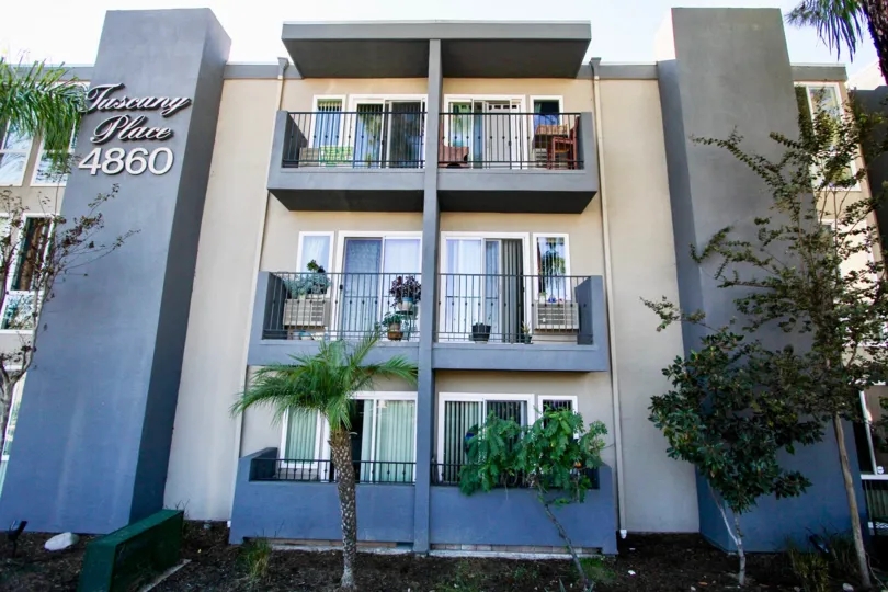Three story residential building with trees at Tuscany Place in College Area California