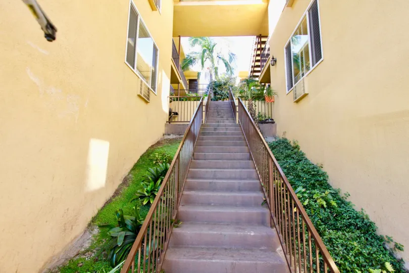 Villa Toscana yellow building and stairwell with landscaping College Area California