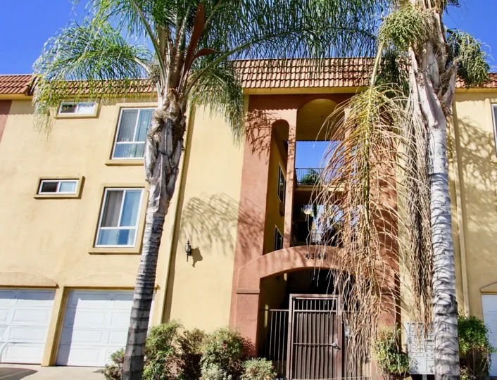 Light brown units with garages and a gate in Villa Toscana of College Area, California