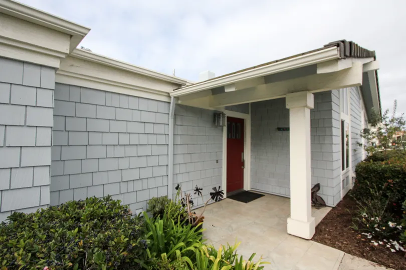 The entrance of a home with a red door and siding in Bahama Village