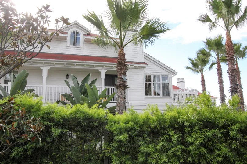 Palm trees and a white building at Beach Village At The Del in Coronado CA