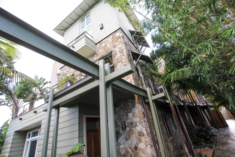 Three story housing near trees at Bridgend Lanai in Coronado California