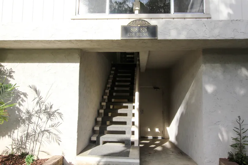 Gray stairway leading up to a residence at Casa Del Sol in Coronado CA