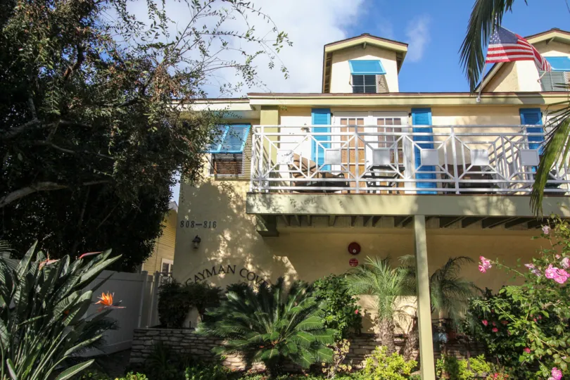 Three story housing with flag out front at Cayman Cove in Coronado California