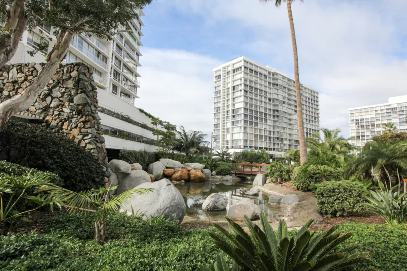 Rock stream flowing inside the Coronado Shores beside high rise apartments.