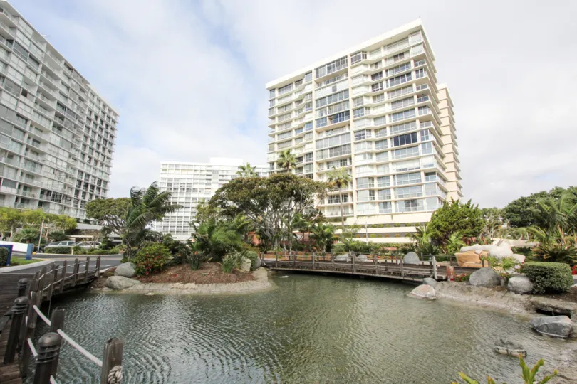 Apartment high rises surround a landscaped pond in Coronado Shores