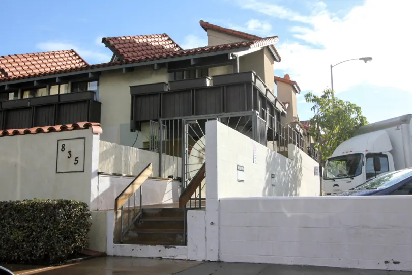 Housing with stairway and parking lot at Garden of the Sun in Coronado California