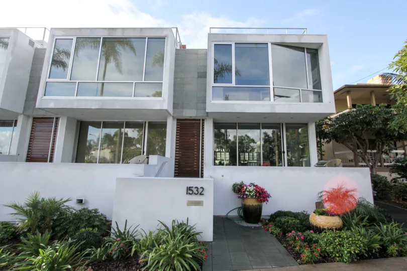Two story housing with plants and security wall at Glorietta Bay Point in Coronado California