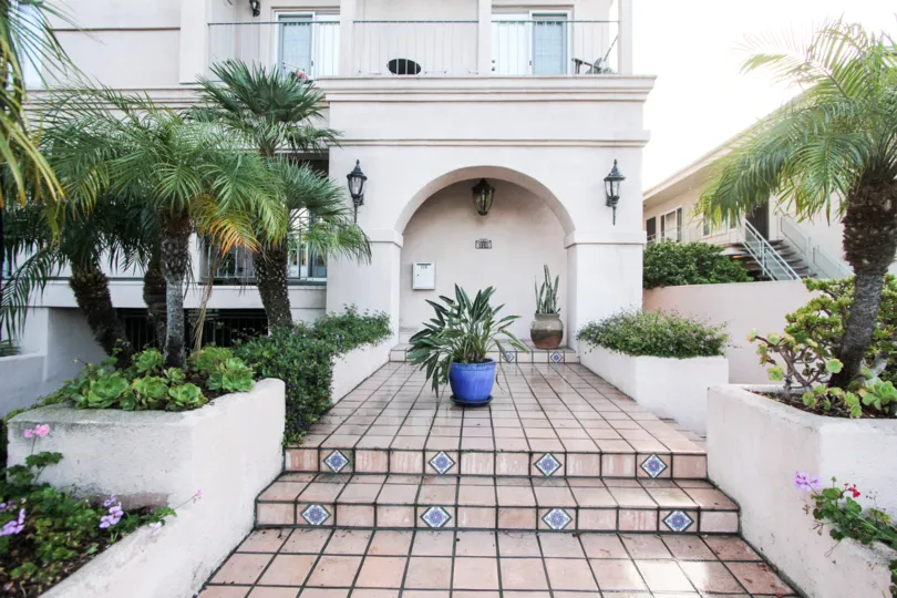 A tiled walkway leads to the entrance to a residence in Harborside Court