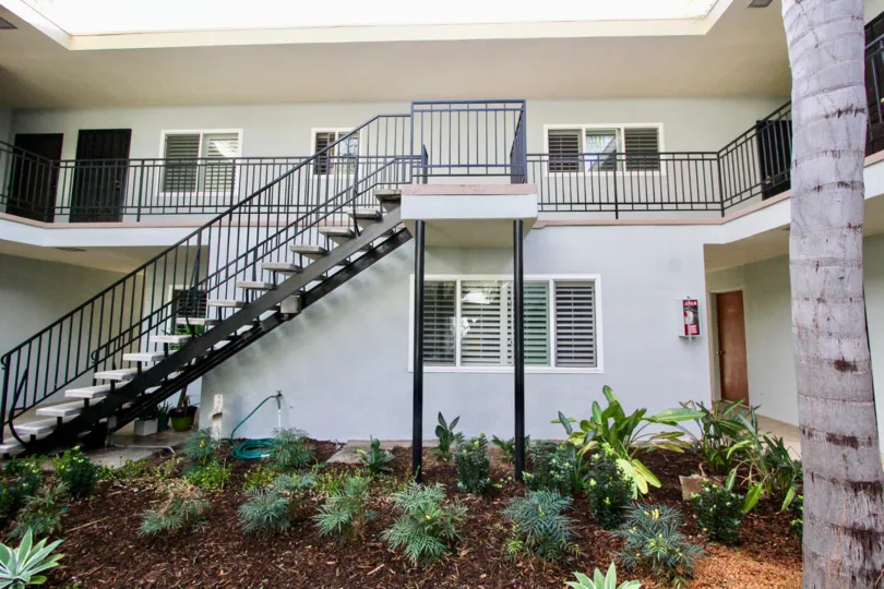 Two story housing with pLe nts and trees in Le  Martinique in Coronado California