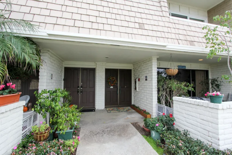 Two story residential units with plants at Montego Village in Coronado California