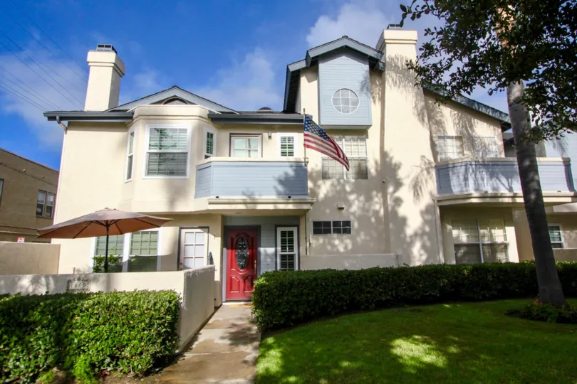 A large home with a red door on a sunny day in Oxford park Coronado California
