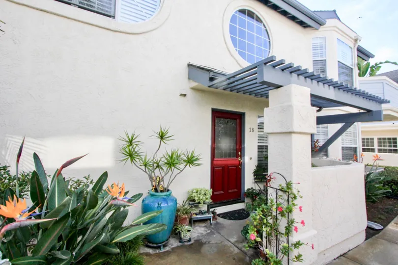 Two story housing with plants and awning at Oxford Park in Coronado California