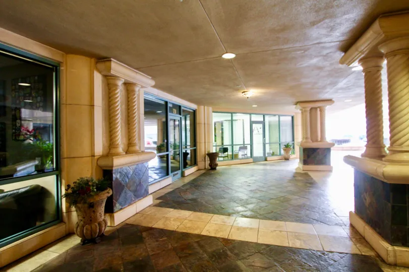 Marble walkway with fancy pillars and ceiling mounted lighting at Regatta Bay in Coronado CA