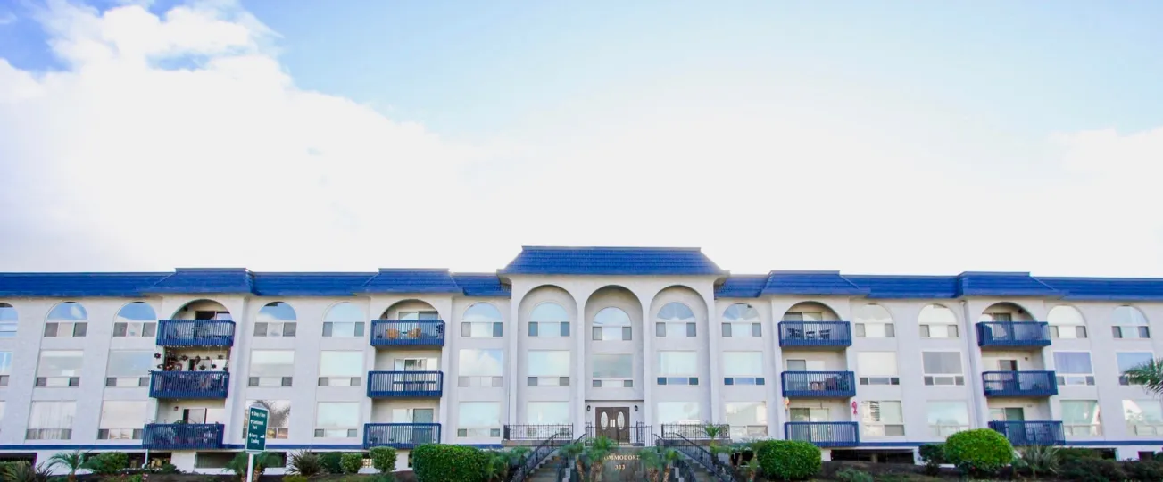 White color building in with blue roof California State in Community of The Commodore in city of Coronado during daytime with blue sky