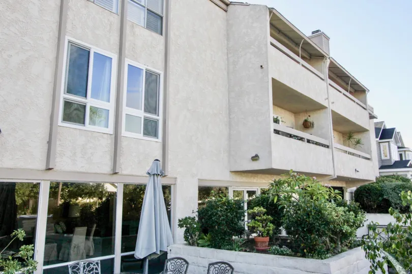 Three story building with trees at Villa Corona in Coronado California