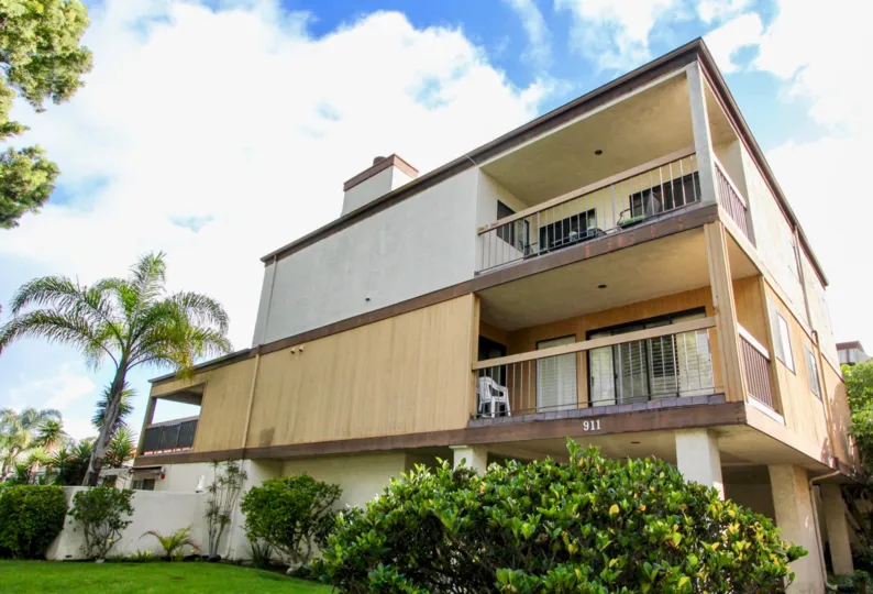 Three story town homes surrounded by plants at Villa Del Sur in Coronado California