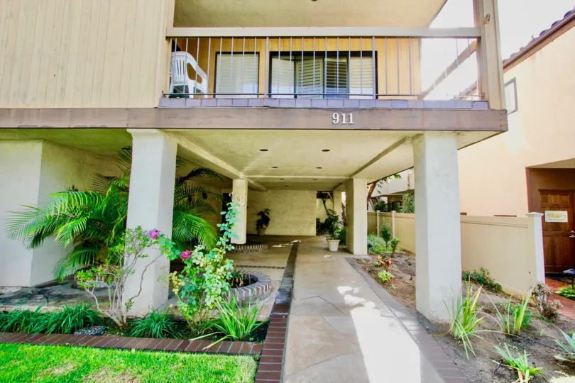 A balcony with a hall below, some lawn and bushes at Villa Del Sur, Coronado, CA
