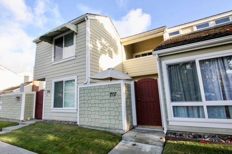 Two story housing units with walkway at Village Townhomes in Coronado California