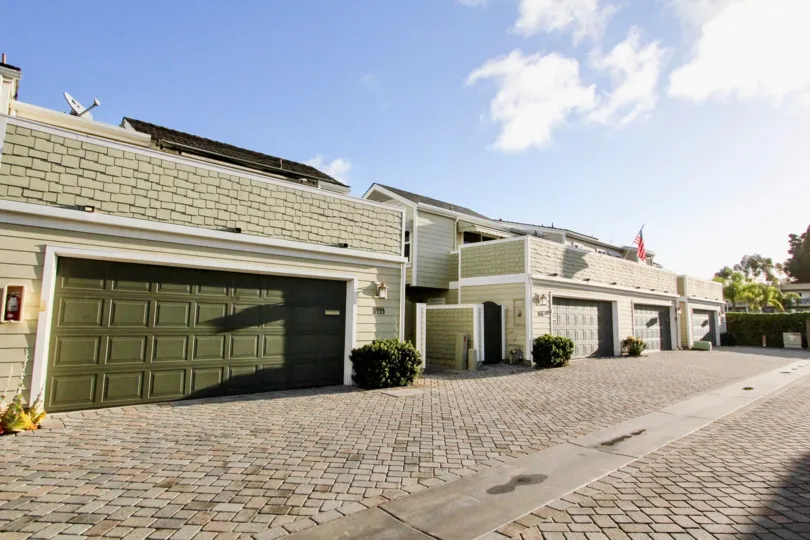 A sunny day in the parking area for Village Townhomes