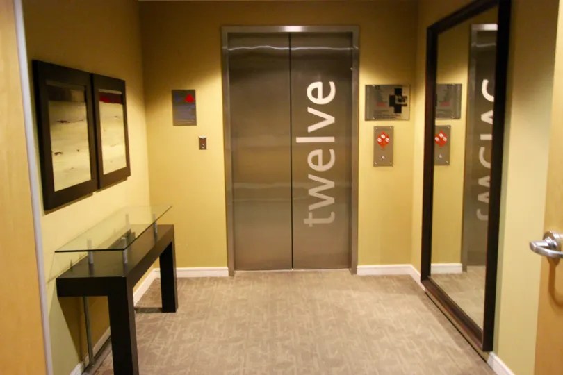 Two silver elevator doors inside 350 West Ash in Downtown San Diego