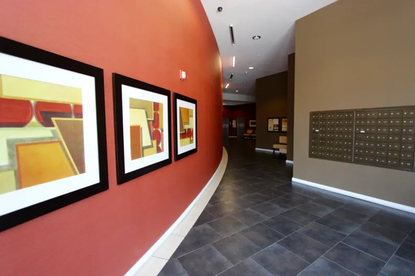 Three painting line a coral colored wall at 350 West Ash