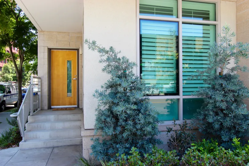 Residence with a wood & glass door inside Acqua Vista at Downtown San Diego CA