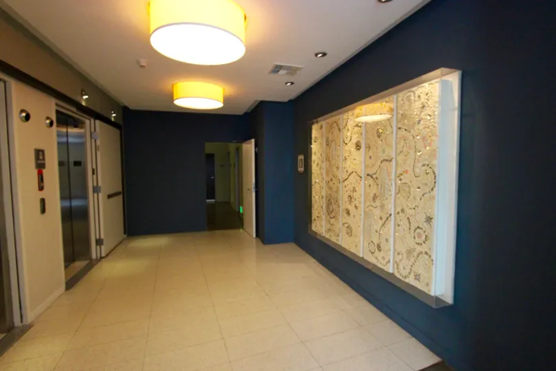 An intimately lit common room in San Diego California with large wall art