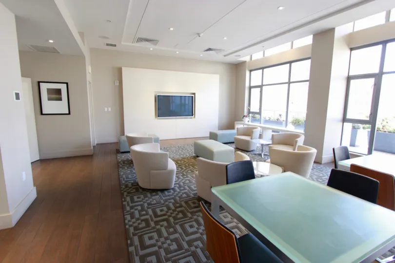 A sunny day in a meeting room with tables and chairs.