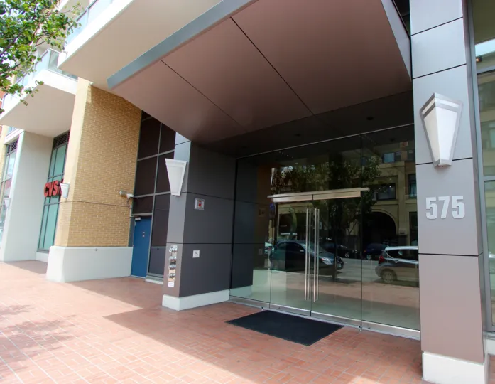 The glass door entry to a building in Alta on a sunny day near downtown San Diego, CA