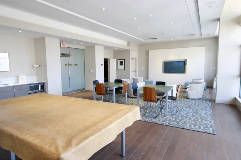 A modern interior with large screen TV and natural lighting in Alta