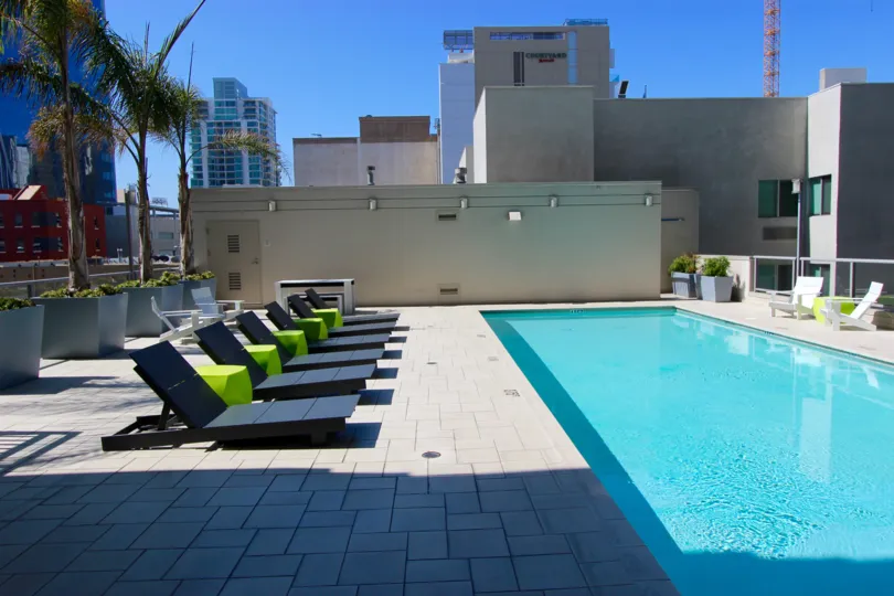 Secluded pool with lounge chairs and city views at Alta in Downtown San Diego, California