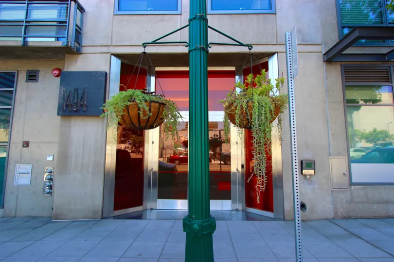 The exterior doors of the modern concrete and glass Aperture building in downtown San Diego.