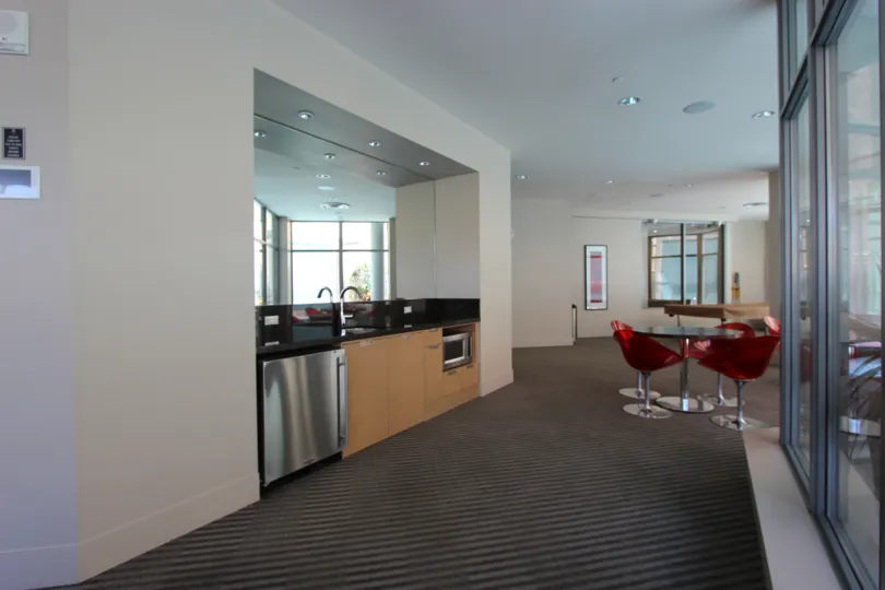 An interior in the Aria with red color chair and wash base.