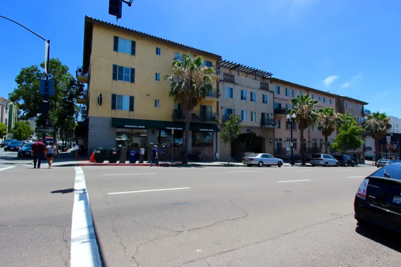 Bella Via, City: Downtown San Diego, a wide road and buildings, cars moving and people walking