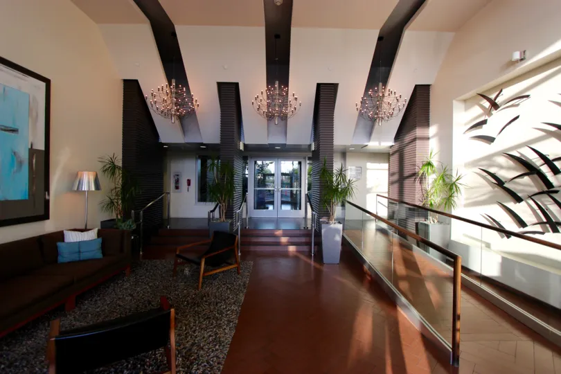 A sunny room in the Breeza community of downtown San Diego, California with three chandeliers