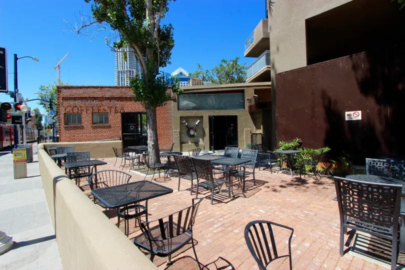 A sunny day at the patio with tables and chairs at Brickyard.