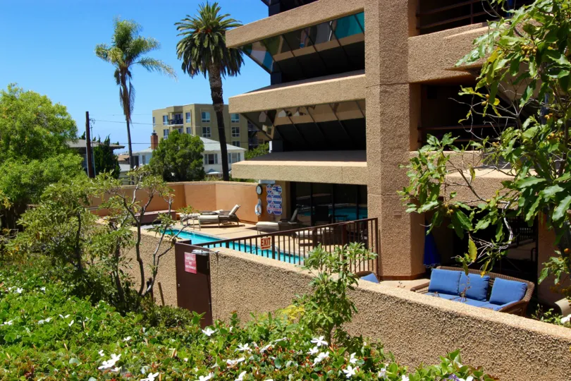 An exterior view of the private swimming pool and outdoor seating area atBrittany Town in downtown San Diego, CA