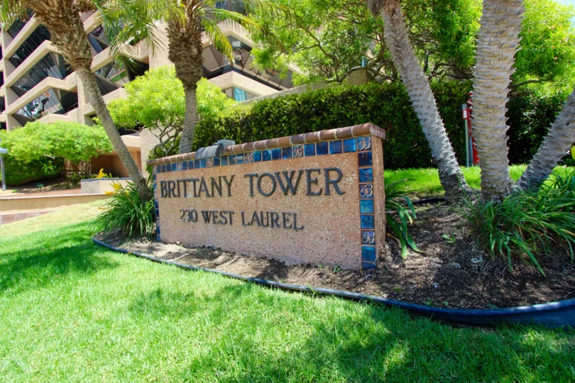 The entry sign with beautiful landscaping at Brittany Tower.