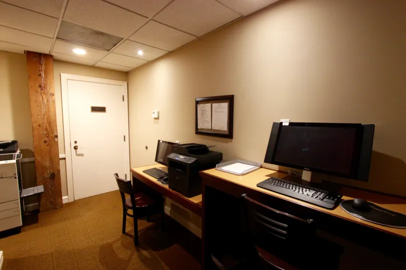 A view of the interior of an office at the Cityfront Terrace with computer desks and a printer.