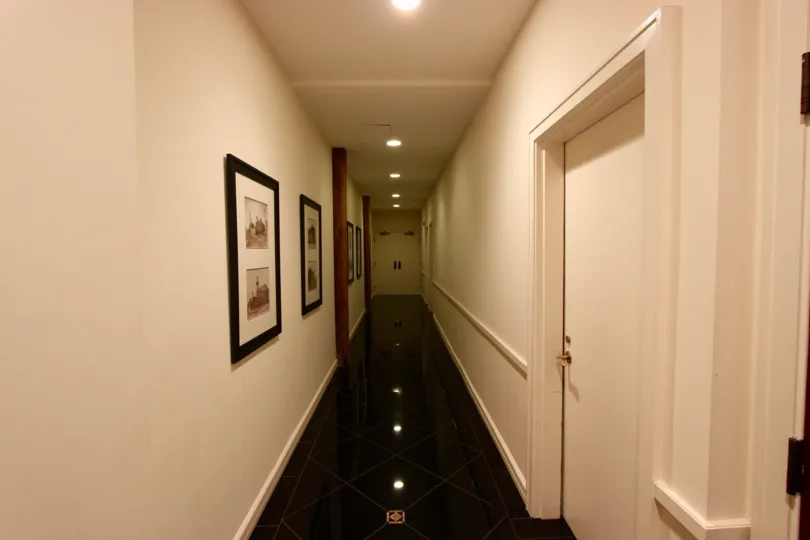 Black shiny tiles on a diagonal line a dim hallway at Cityfront Terrace