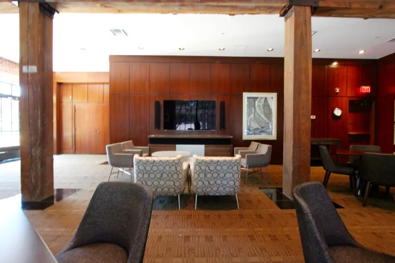 Room filled with furniture and wood paneled walls inside Cityfront Terrace at Downtown San Diego CA