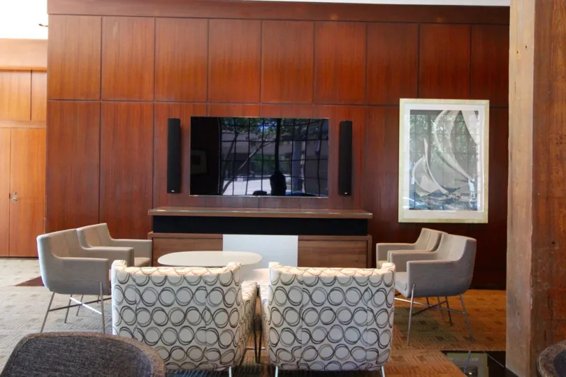 A living room in Cityfront Terrace with television and chairs.