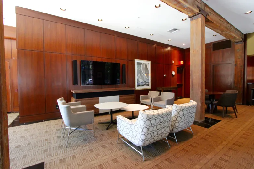 Wooden wall separation in the middle of the area with sofa decoration in Cityfront Terrace.