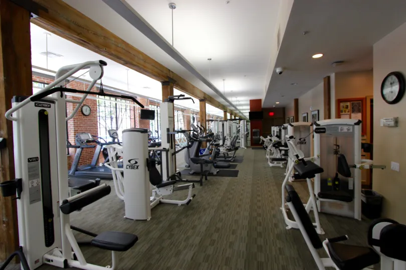 THE JIM IN THE CITYFRONT TERRACE WITH EXERCISE EQUIPMENT, WALL CLOCK.