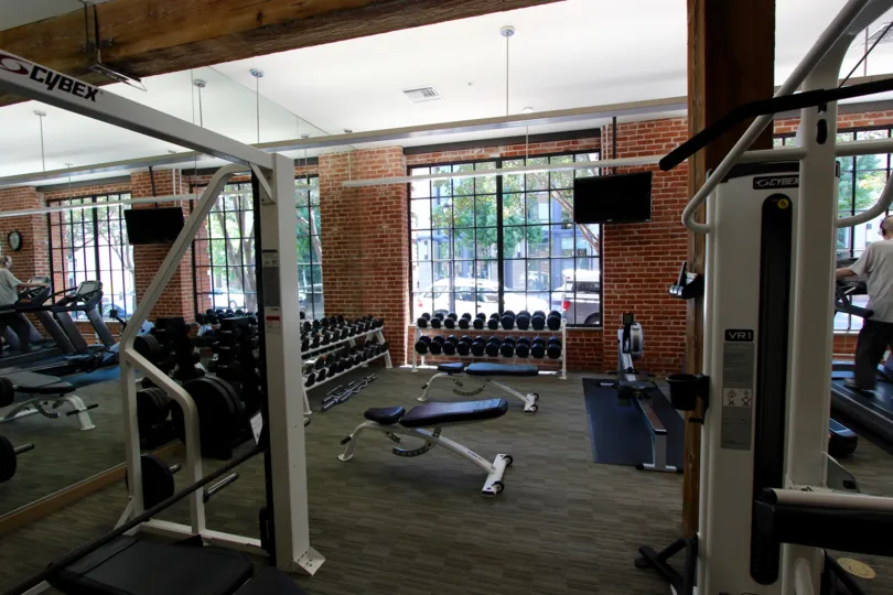 A row of barbells sits on a rack in a fitness room at Cityfront Terrace