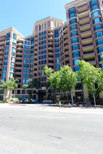 Condominium high rise with many blue glass windows at Cityfront Terrace inside Downtown San Diego CA